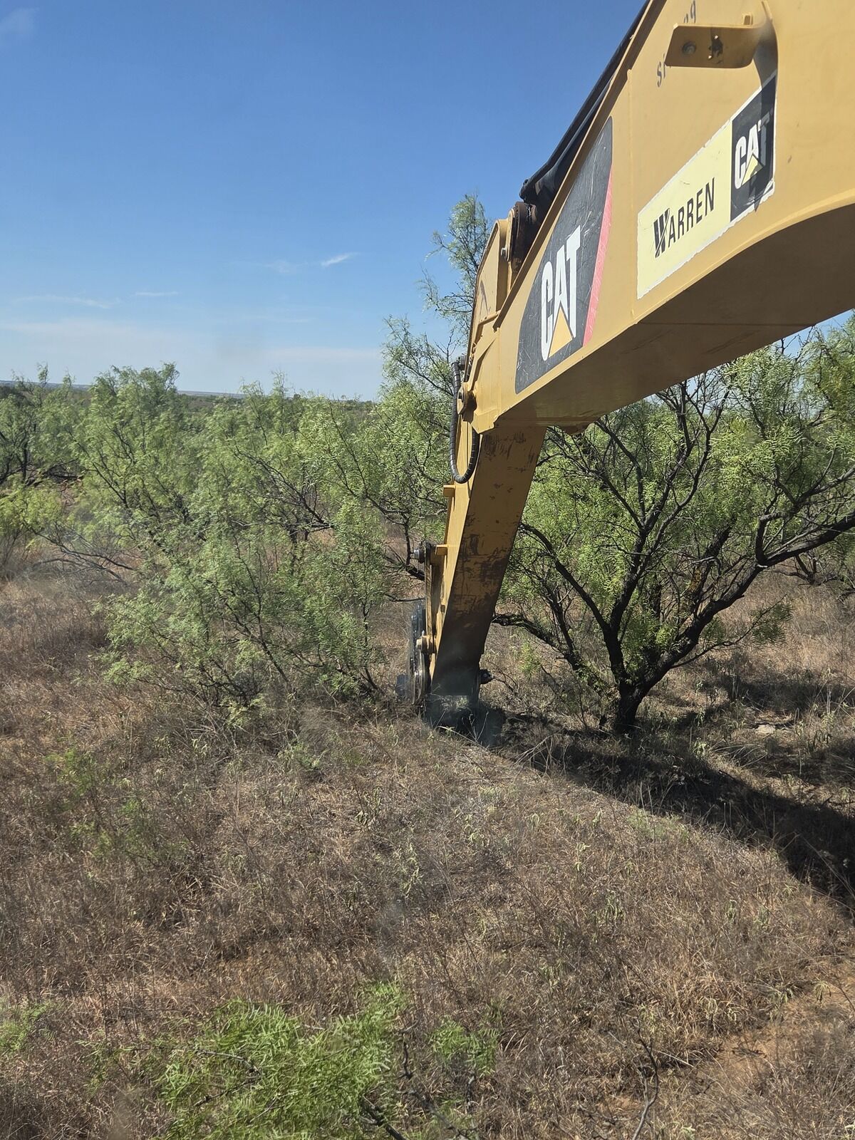 Excavator working mesquite on a Texas Panhandle ranch