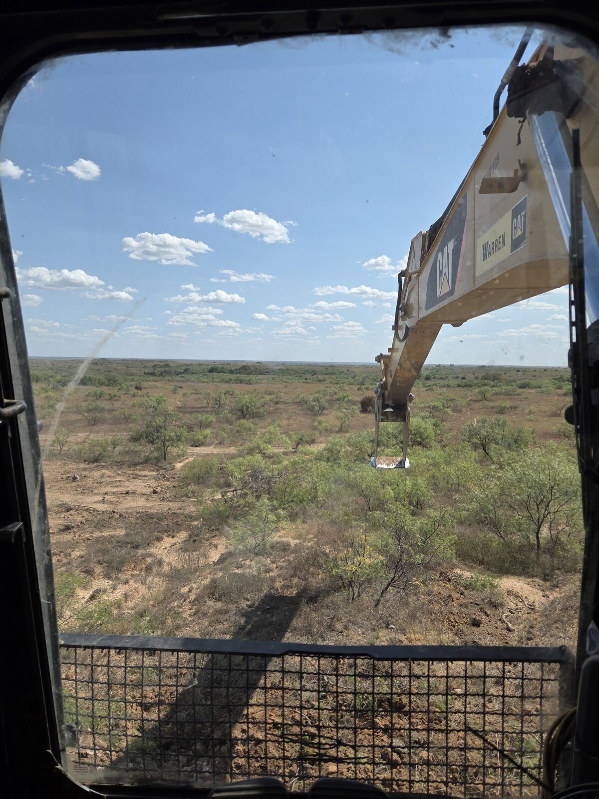 Grubbing mesquite from the excavator cab on a Panhandle ranch